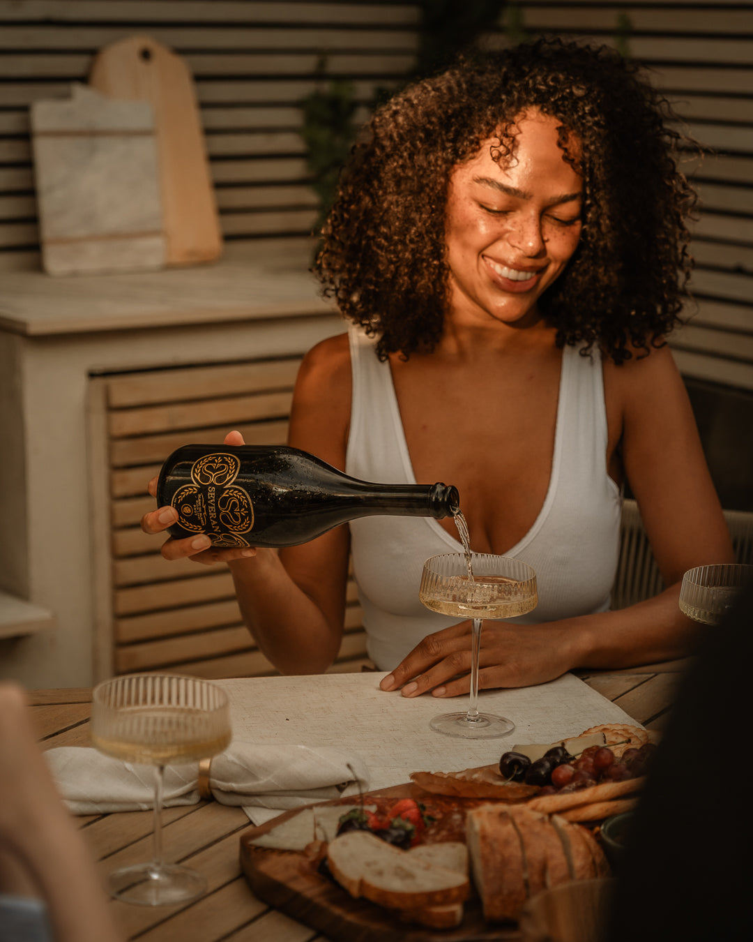Severan being poured at a table laid for friends at golden hour